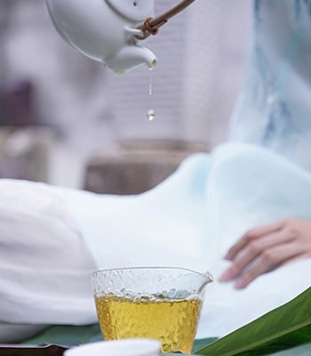 Fancy Image of Tea dripping into a glass from a Chinese pot